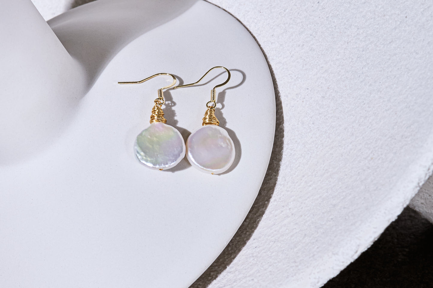Credo coin pearl earrings set in gold wirework