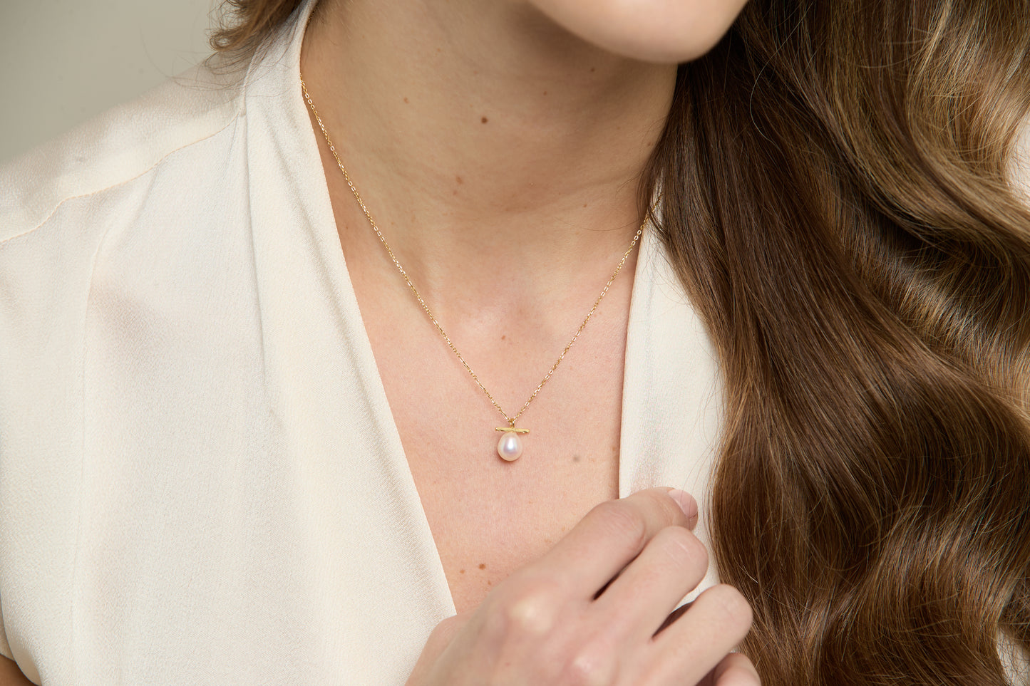 Gratia gold plated sterling silver chain with central white cultured freshwater pearl beneath delicate bar