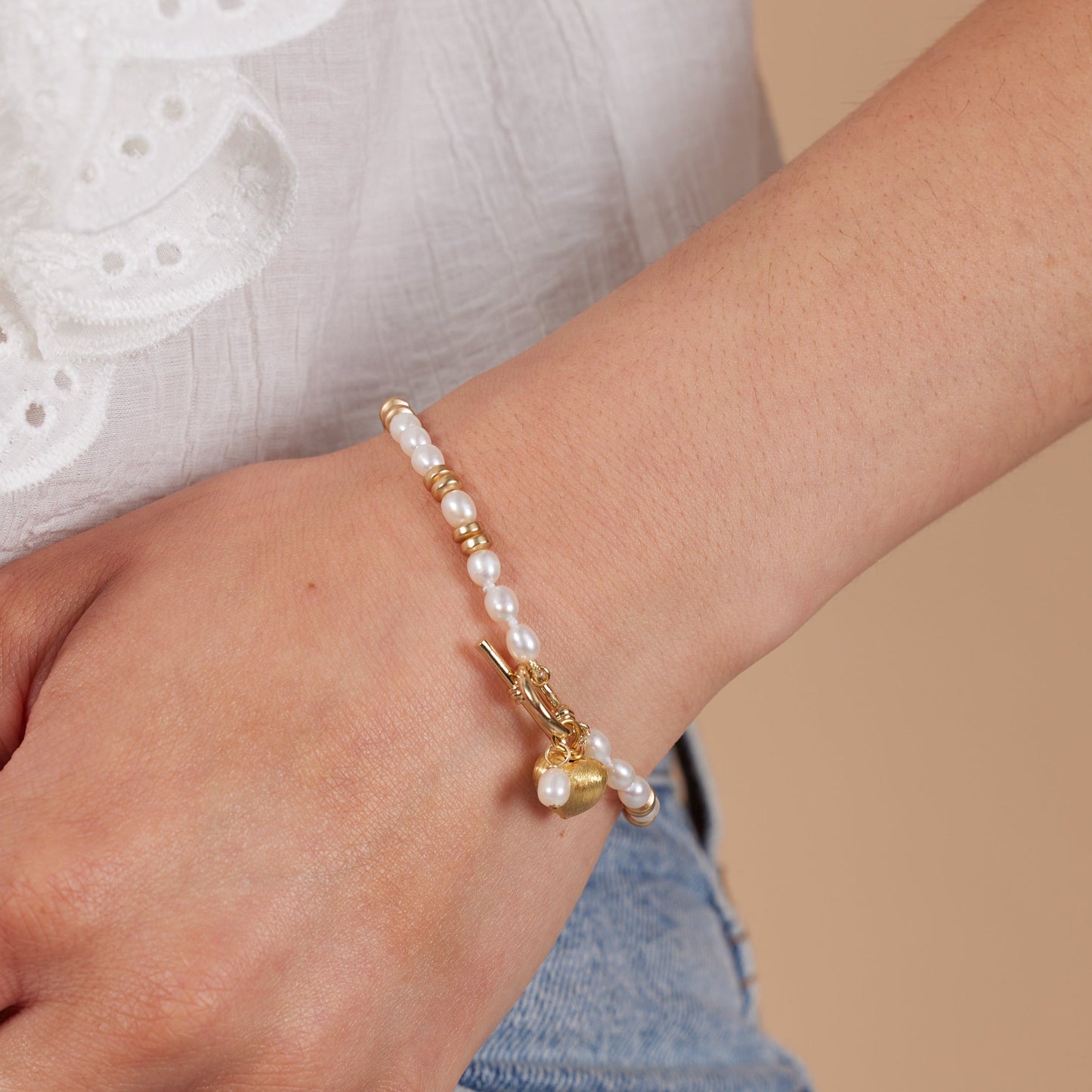 Amare white cultured freshwater pearl bracelet with gold hematite beads & a gold heart charm