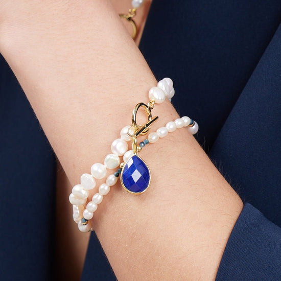 Clara white irregular cultured freshwater pearl bracelet with a lapis lazuli drop pendant