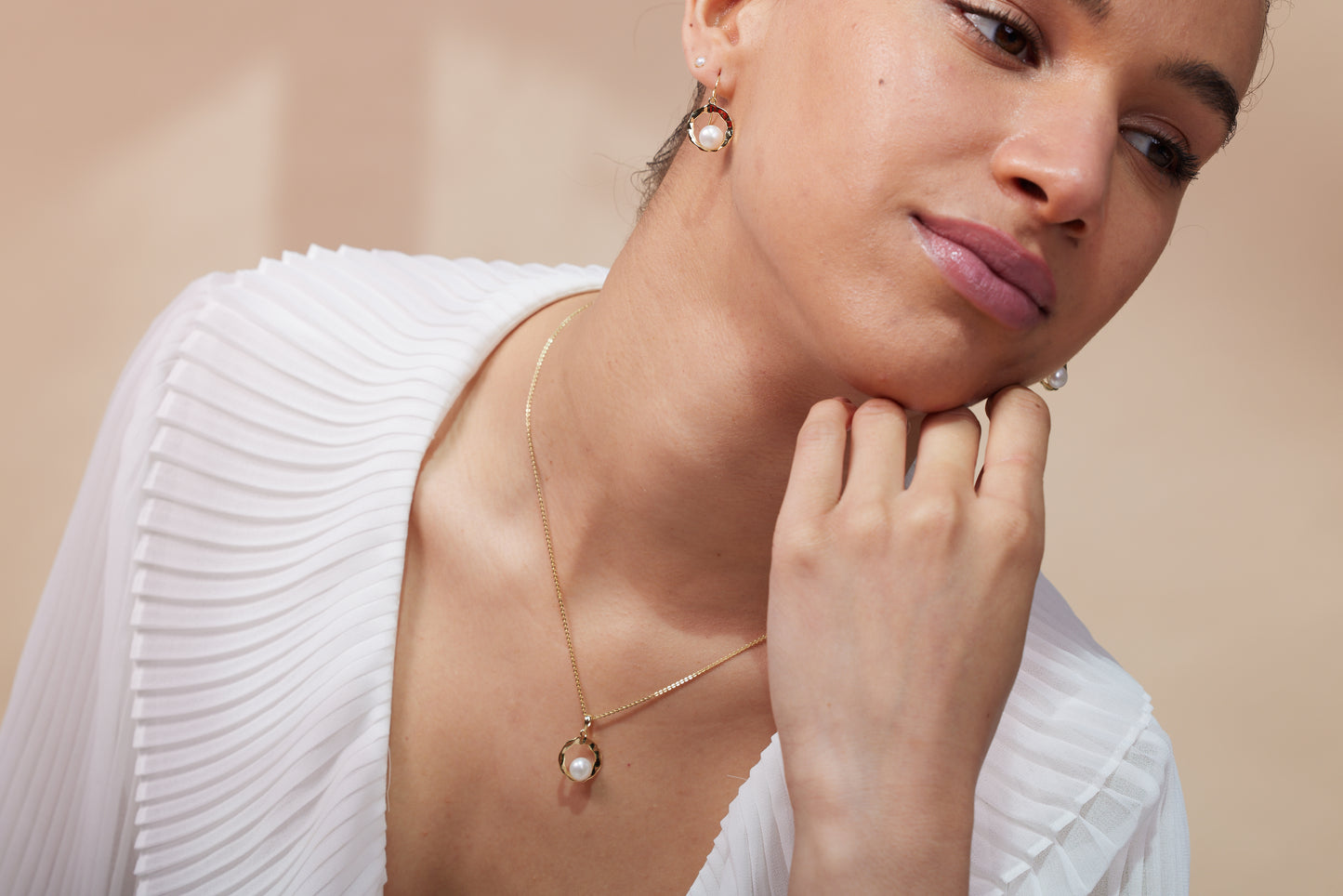 Credo gold hollow disk pendant with cultured freshwater pearl in the centre