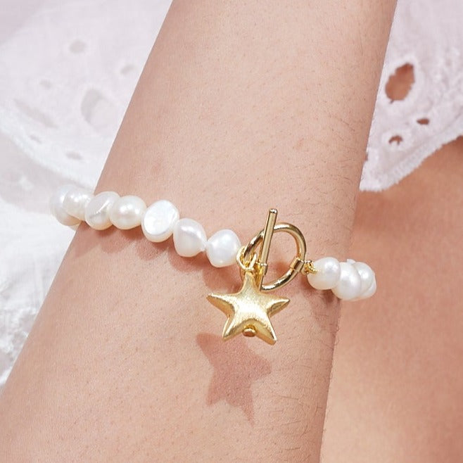 
                  
                    Stella cultured freshwater irregular pearl bracelet with a gold-plated star charm
                  
                