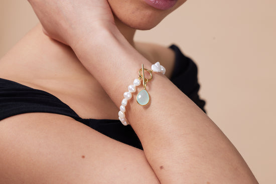 Clara white irregular cultured freshwater pearl bracelet with an aqua chalcedony drop pendant