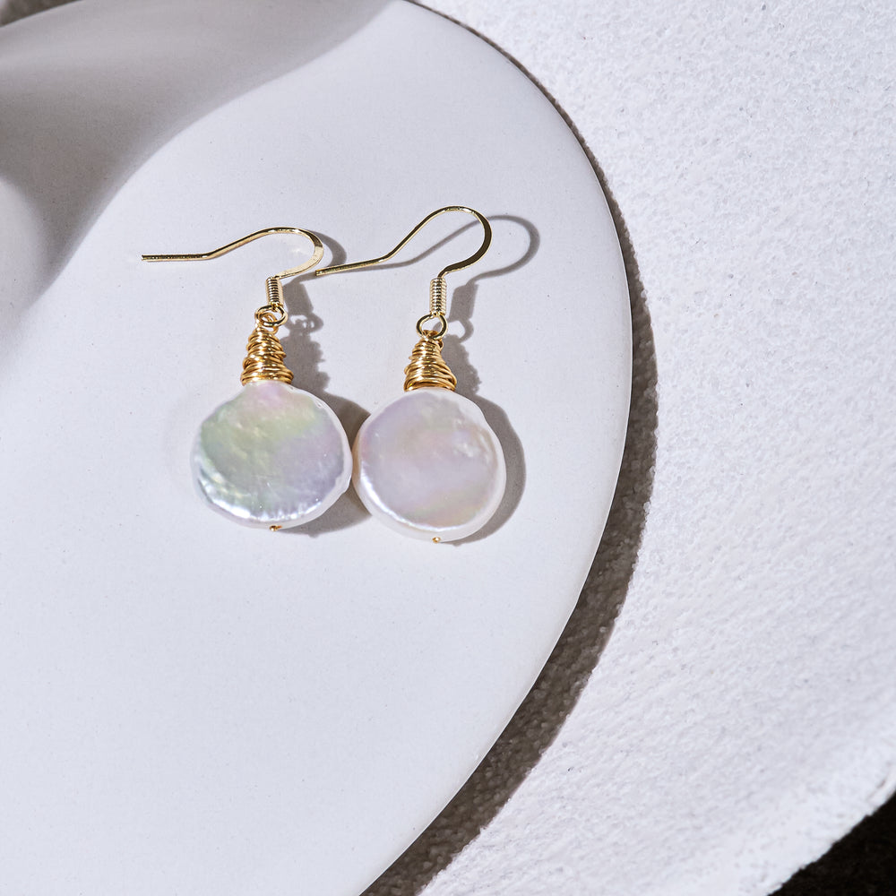 
                  
                    Credo coin pearl earrings set in gold wirework
                  
                