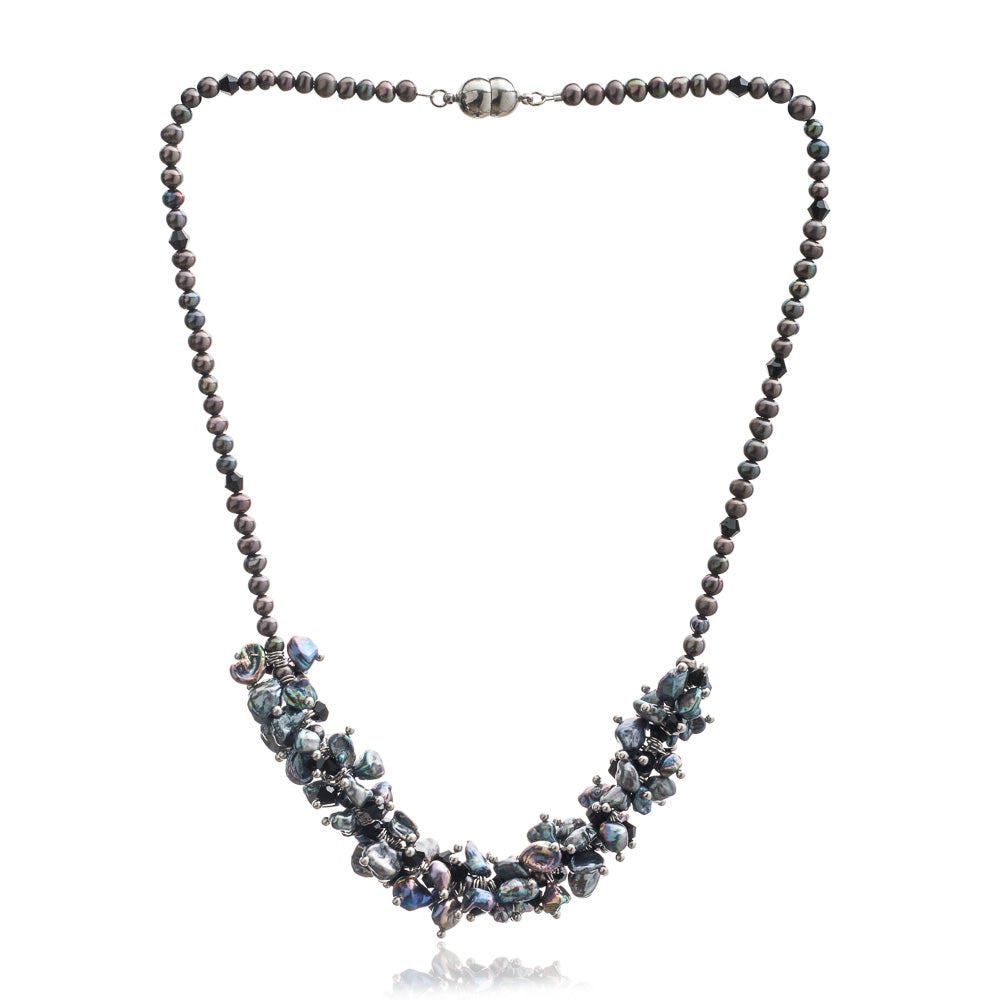 Necklace with peacock black cultured freshwater pearls and black crystals and a magnet clasp on a white background