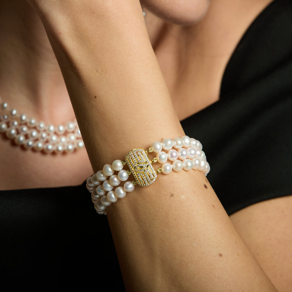 
                  
                    Stella triple strand cultured freshwater pearl bracelet with art deco style gold vermeil pave clasp
                  
                
