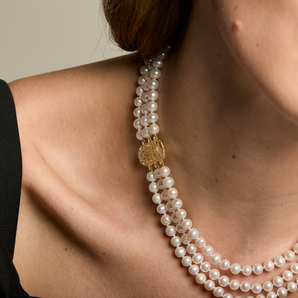 
                  
                    Stella triple strand cultured freshwater pearl necklace with art deco style gold vermeil pave clasp
                  
                