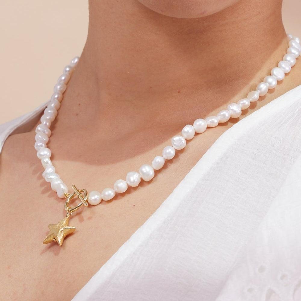 
                  
                    Stella cultured freshwater irregular pearl necklace with a gold-plated star charm
                  
                