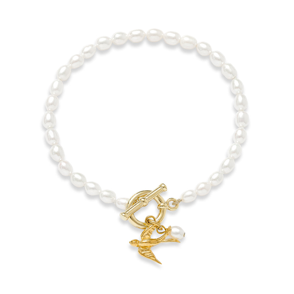 Vita cultured freshwater oval pearl bracelet with a gold-plated swallow charm