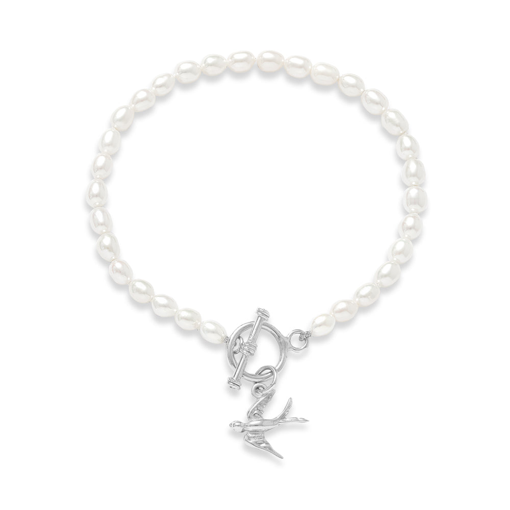 Vita cultured freshwater oval pearl bracelet with a silver swallow charm