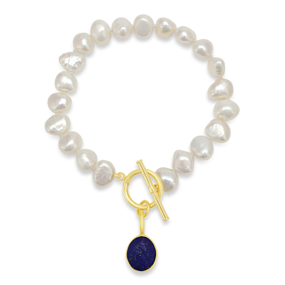 
                  
                    Clara white irregular cultured freshwater pearl bracelet with a lapis lazuli drop pendant
                  
                