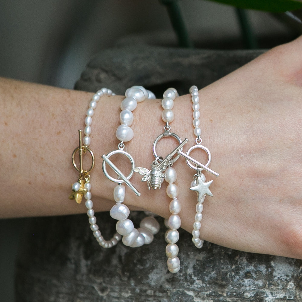 
                  
                    Stella cultured freshwater oval pearl bracelet with a gold-plated star charm
                  
                