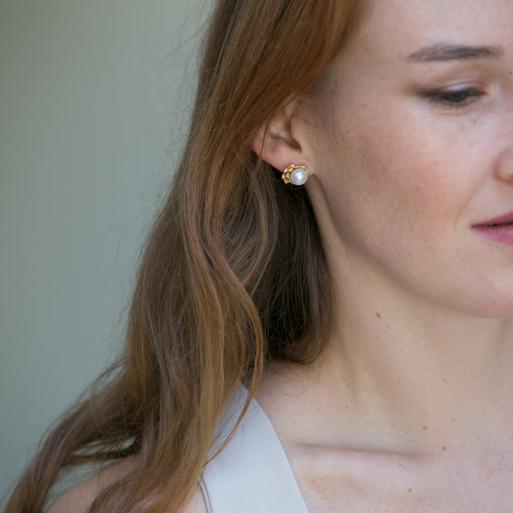 
                  
                    Stella cultured freshwater pearl stud earrings with gold sparkle swirl
                  
                